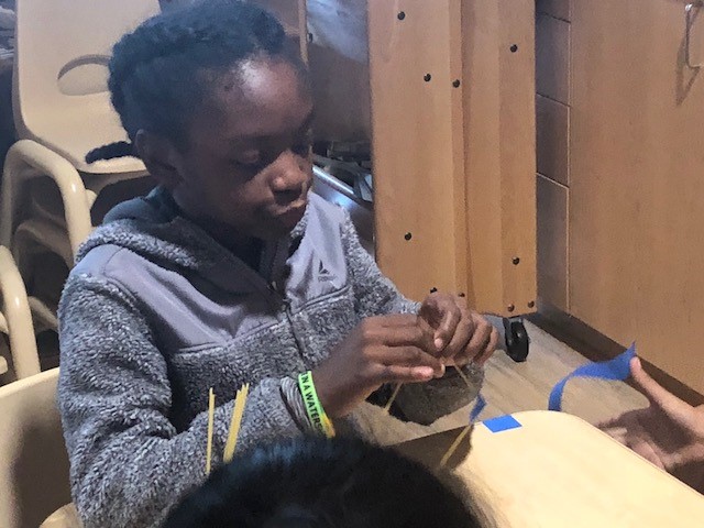 one student builds tower's foundation